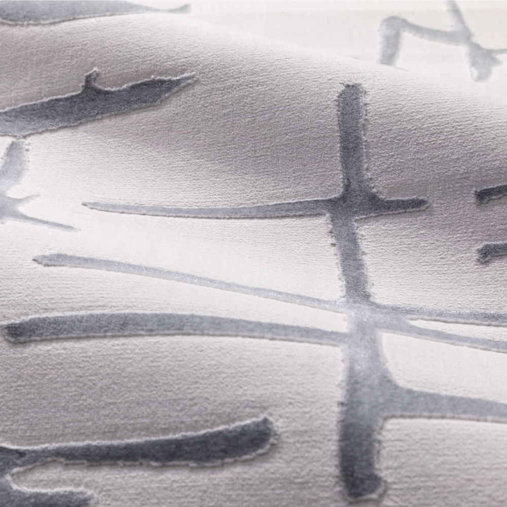 Gideon Strip Textured Rug featuring elegant grey lines on a soft surface.