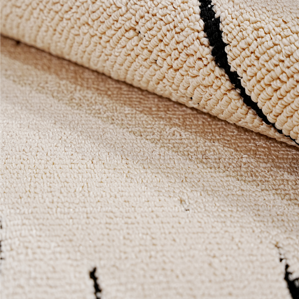 Close-up of Marlow Abstract Textured Rug, cream and black, modern washable design