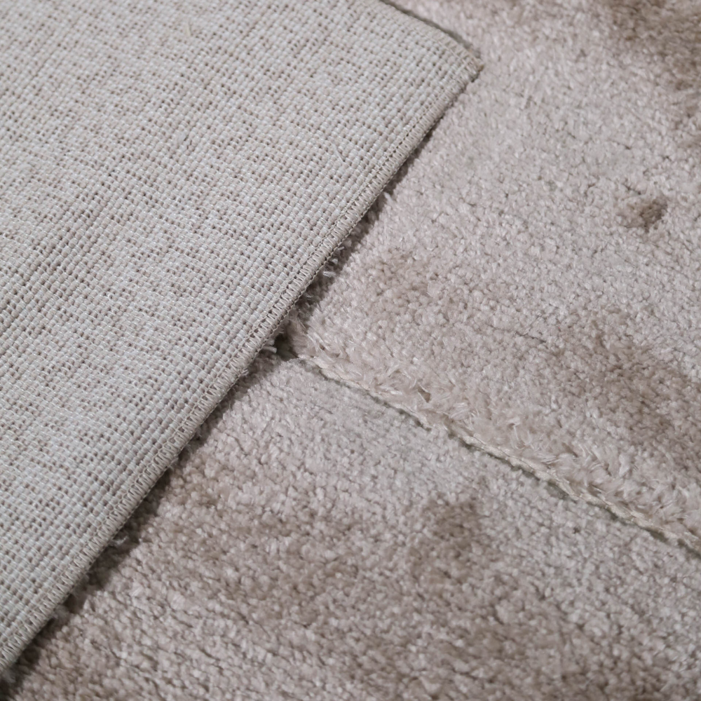 Soft light Callidora geometric rug detail highlighting texture and design.