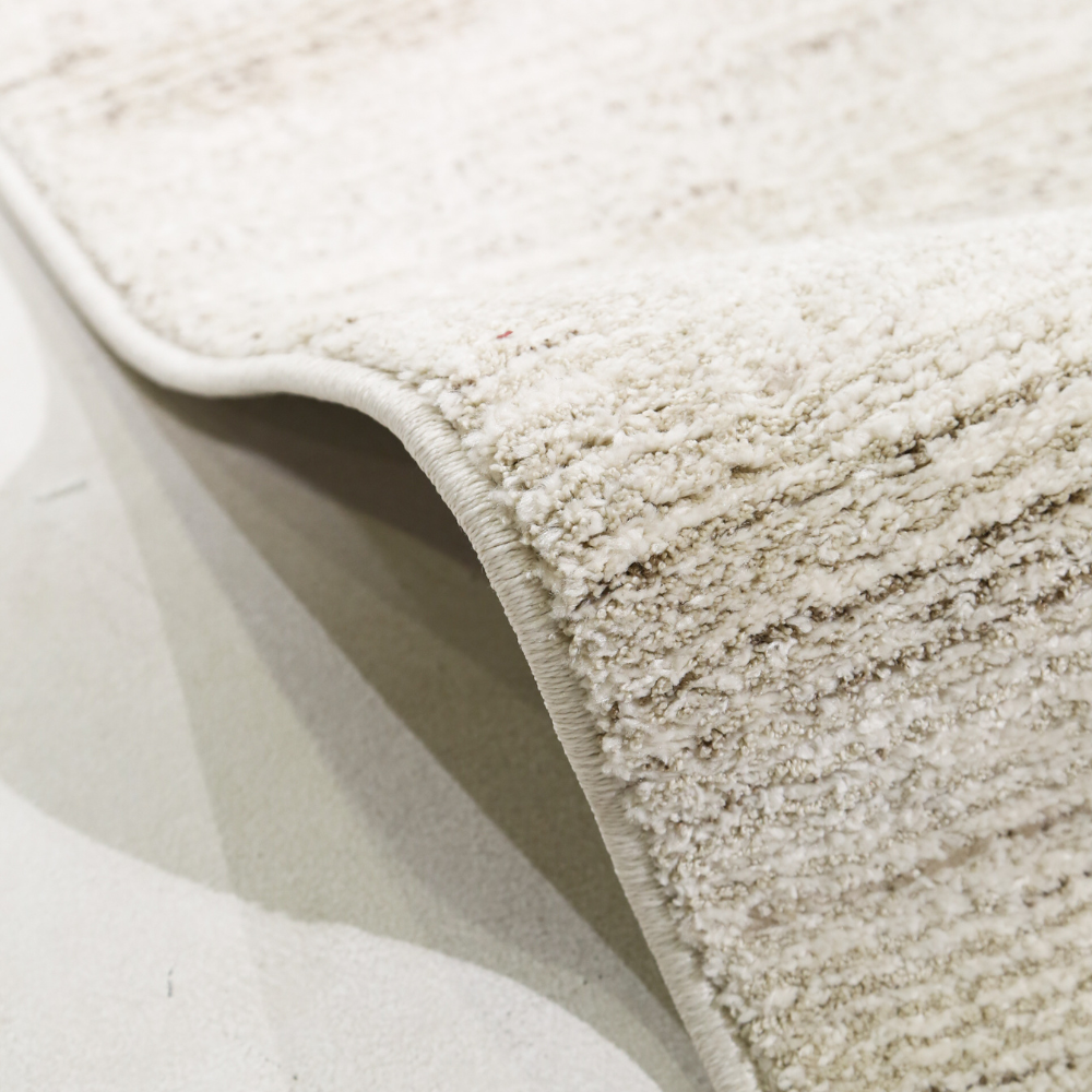 Light Romulus textured rug with soft fibers, ideal for contemporary home interiors.