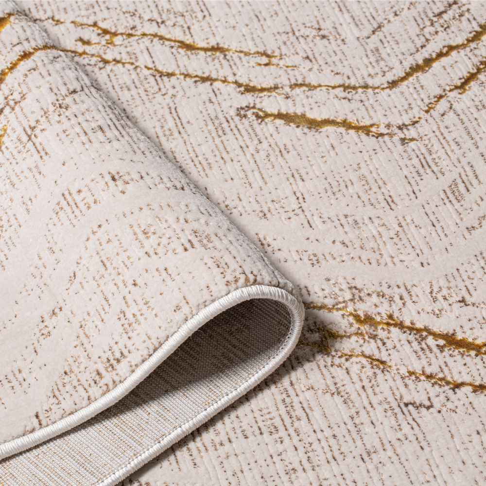 Textured zigzag rug with gold highlights, perfect for modern home decor.